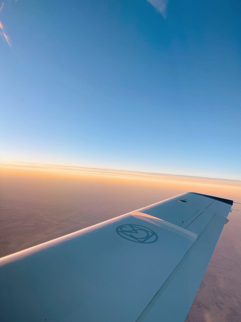 plane flying during sunset as a thumbnail image for long-haul flight essentials