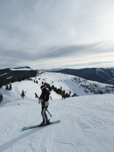 woman overlooking the mountains while skiing in vail, colorado