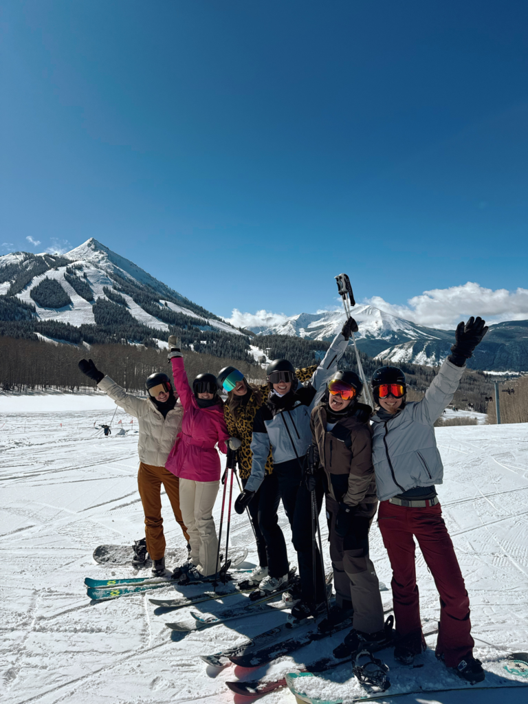 Girls posing in ski outfits on a Colorado ski trip to Crested Butte.