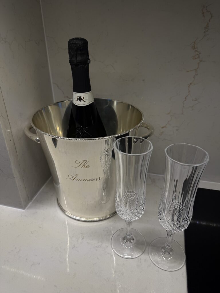 Silver champagne bucket with two crystal champagne flutes for a romantic couple's getaway.